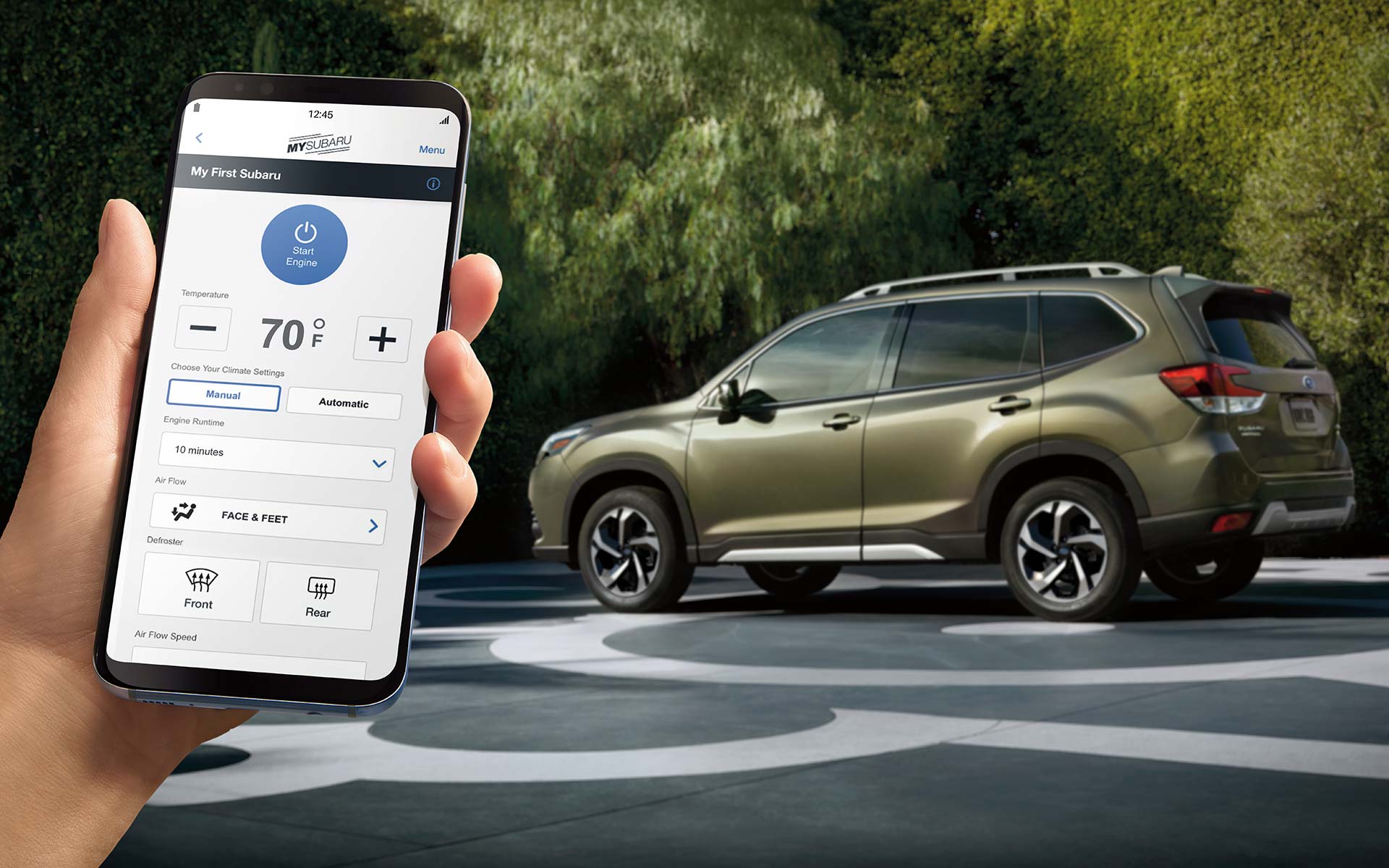 A close-up of a phone showing the Remote Engine Start with Climate Control feature of SUBARU STARLINKĀ® Safety and Security available on the 2022 Forester.